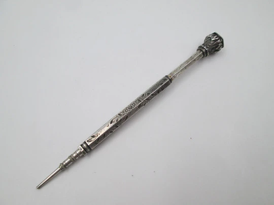 Mechanical propelling twist pencil. Chiselled silver and amber stone. 1900's