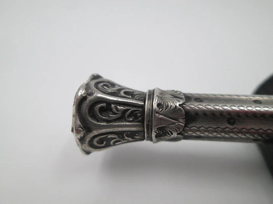 Mechanical propelling twist pencil. Chiselled silver and amber stone. 1900's