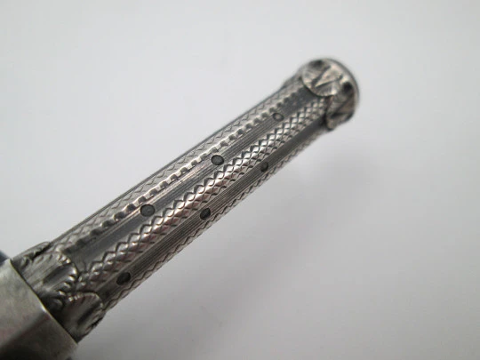 Mechanical propelling twist pencil. Chiselled silver and amber stone. 1900's