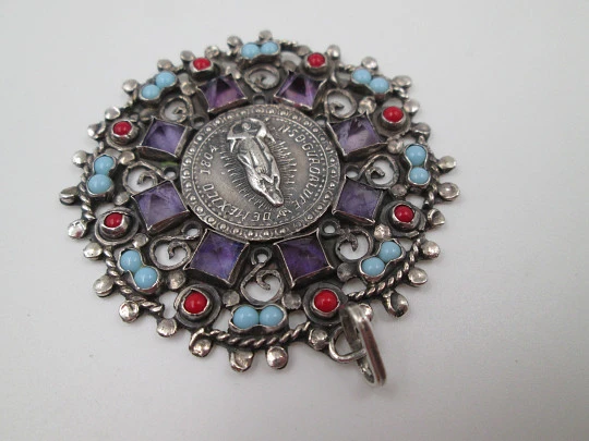 Medalla colgante Virgen de Guadalupe. Plata de ley. Amatistas, turquesas y corales. 1960