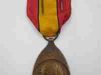 Medalla Primera Guerra Mundial. Bronce. Bélgica. 1919. Banda tela