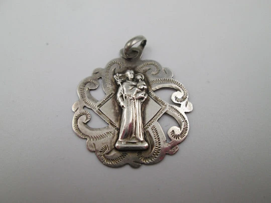 Medalla religiosa calada. San José con el Niño. Plata de ley. Asa y argolla. Europa. 1940