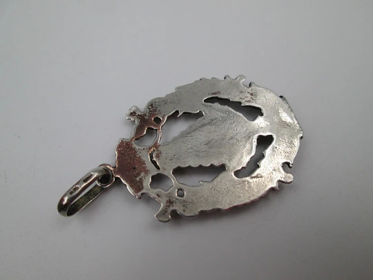 Medalla religiosa calada. Virgen María con manto y bastón de mando. Plata de ley. 1960