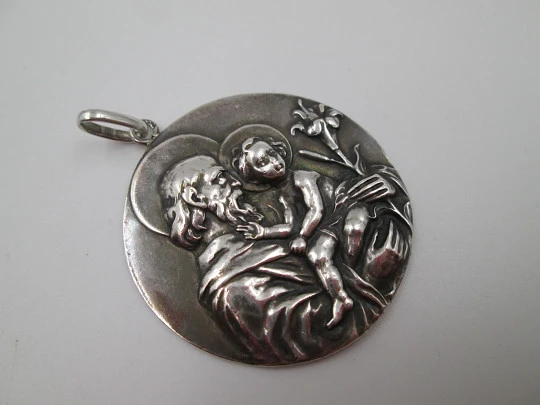 Medalla San José con el Niño. Plata de ley. Alto relieve. Asa y argolla. 1950. España