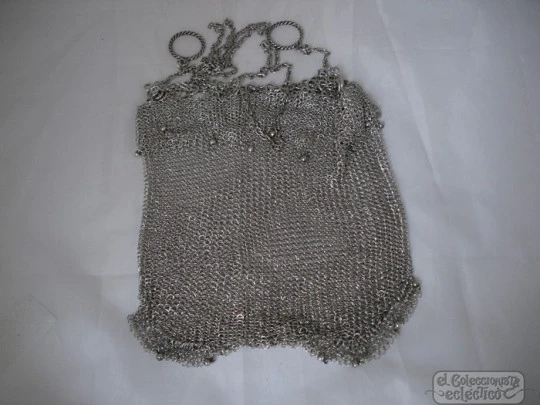 Mesh finger bag. Silver. Fringes and balls. Chain. Circa 1920's