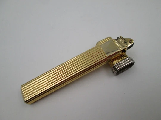 Mica pocket butane lighter. Gold plated and silver metal. Linear pattern. South America
