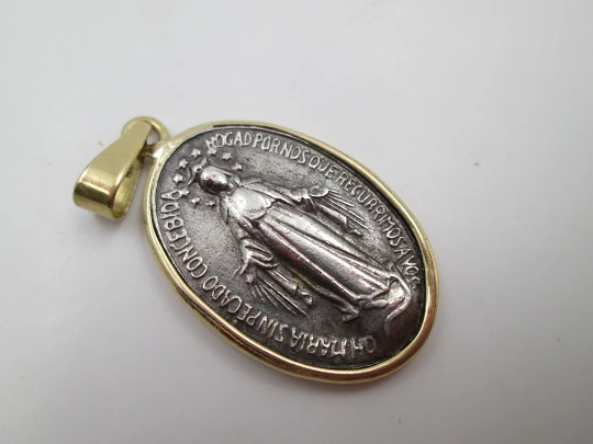 Miraculous Virgin Medal. 925 sterling silver. 18 karat gold edge and ring. Spain. 1940's