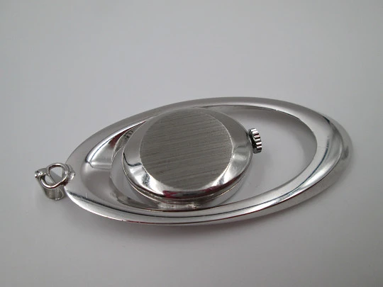 Mortima pendant watch. Silver plated metal. Bitone dial. Elliptical shape. France. 1970's