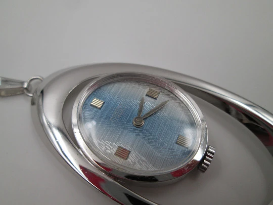 Mortima pendant watch. Silver plated metal. Bitone dial. Elliptical shape. France. 1970's