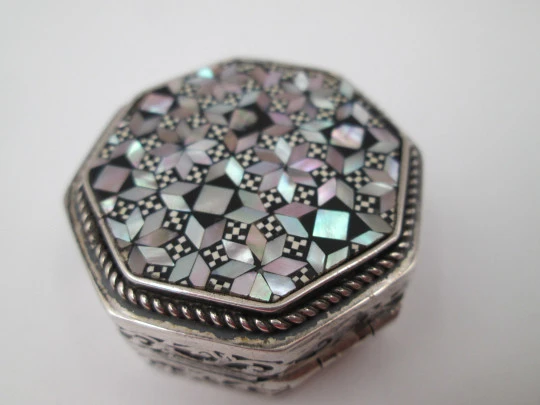 Octagonal pillbox. Sterling silver. Checkered mother-of-pearl front. Vegetable ornates