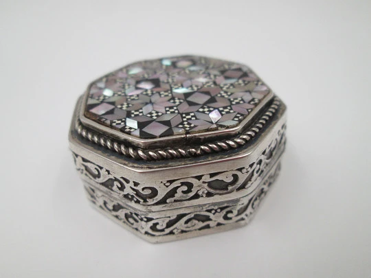Octagonal pillbox. Sterling silver. Checkered mother-of-pearl front. Vegetable ornates