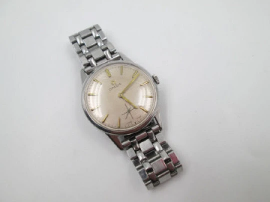 Omega caballero. Acero inoxidable. Cuerda manual. Segundero. Brazalete. 1960