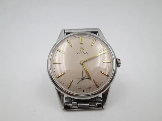 Omega caballero. Acero inoxidable. Cuerda manual. Segundero. Brazalete. 1960