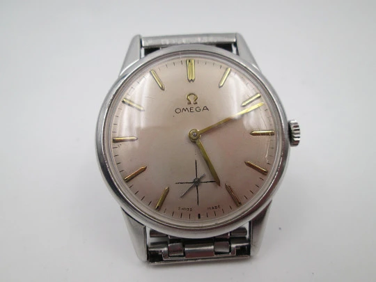 Omega caballero. Acero inoxidable. Cuerda manual. Segundero. Brazalete. 1960