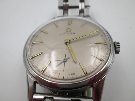 Omega caballero. Acero inoxidable. Cuerda manual. Segundero. Brazalete. 1960