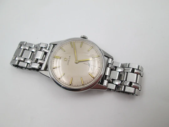 Omega caballero. Acero inoxidable. Cuerda manual. Segundero. Brazalete. 1960