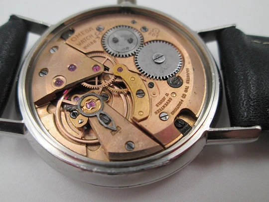 Omega Genève. Stainless steel. Circa 1960's. Manual wind. Black strap