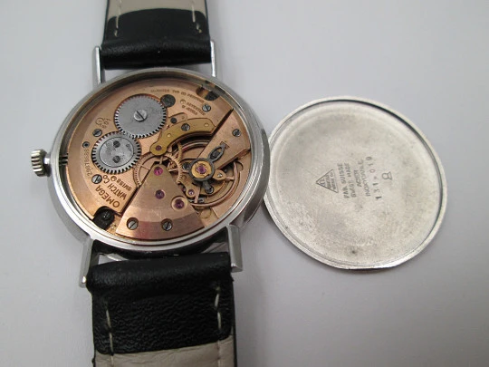 Omega Genève. Stainless steel. Circa 1960's. Manual wind. Black strap