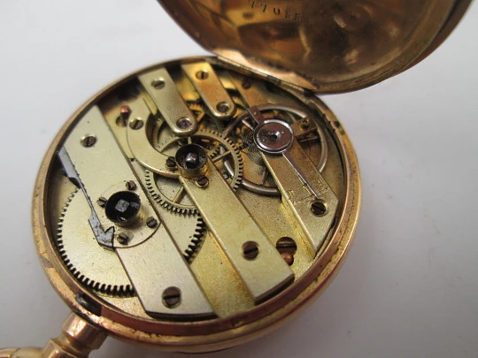 Open-face pocket watch. 14 karat yellow gold. Key-wind movement. Floral motifs. 1890's