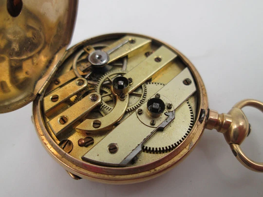 Open-face pocket watch. 14 karat yellow gold. Key-wind movement. Floral motifs. 1890's