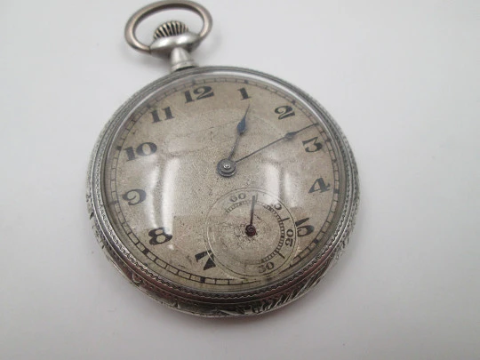 Open face pocket watch. 800 sterling silver. Ornate back. Small second hand