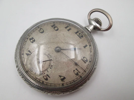 Open face pocket watch. 800 sterling silver. Ornate back. Small second hand