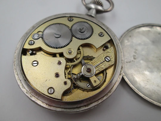 Open face pocket watch. 800 sterling silver. Ornate back. Small second hand