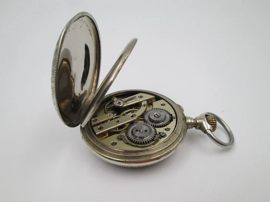 Open-face pocket watch. Nickel plated metal. Stars pattern. Stem-wind. Bitone dial. 1920's Open-face pocket watch. Nickel plated metal. Stars pattern. Stem-wind. Bitone dial. 1920's