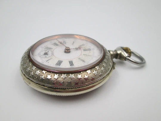 Open-face pocket watch. Nickel plated metal. Stars pattern. Stem-wind. Bitone dial. 1920's Open-face pocket watch. Nickel plated metal. Stars pattern. Stem-wind. Bitone dial. 1920's