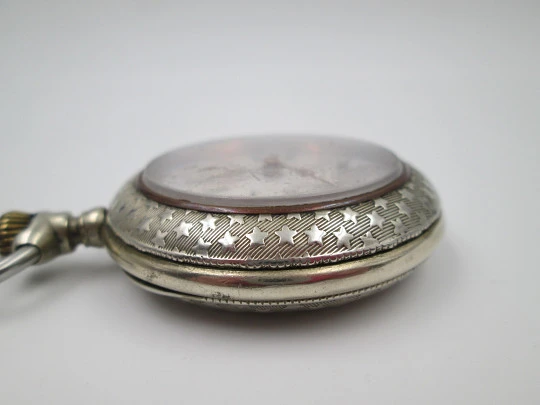 Open-face pocket watch. Nickel plated metal. Stars pattern. Stem-wind. Bitone dial. 1920's Open-face pocket watch. Nickel plated metal. Stars pattern. Stem-wind. Bitone dial. 1920's
