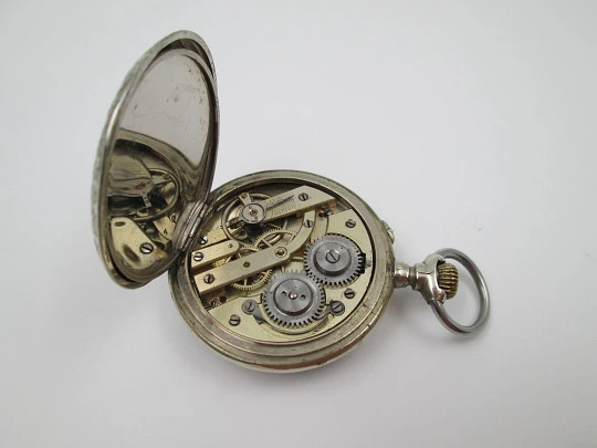 Open-face pocket watch. Nickel plated metal. Stars pattern. Stem-wind. Bitone dial. 1920's