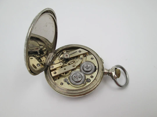 Open-face pocket watch. Nickel plated metal. Stars pattern. Stem-wind. Bitone dial. 1920's Open-face pocket watch. Nickel plated metal. Stars pattern. Stem-wind. Bitone dial. 1920's