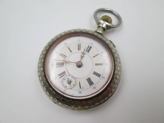 Open-face pocket watch. Nickel plated metal. Stars pattern. Stem-wind. Bitone dial. 1920's Open-face pocket watch. Nickel plated metal. Stars pattern. Stem-wind. Bitone dial. 1920's