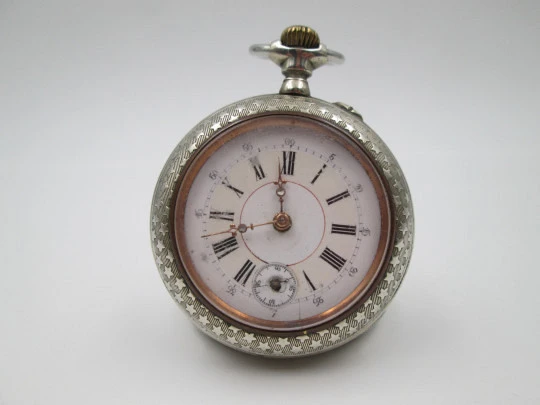 Open-face pocket watch. Nickel plated metal. Stars pattern. Stem-wind. Bitone dial. 1920's Open-face pocket watch. Nickel plated metal. Stars pattern. Stem-wind. Bitone dial. 1920's