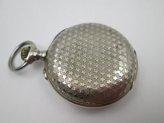 Open-face pocket watch. Nickel plated metal. Stars pattern. Stem-wind. Bitone dial. 1920's Open-face pocket watch. Nickel plated metal. Stars pattern. Stem-wind. Bitone dial. 1920's