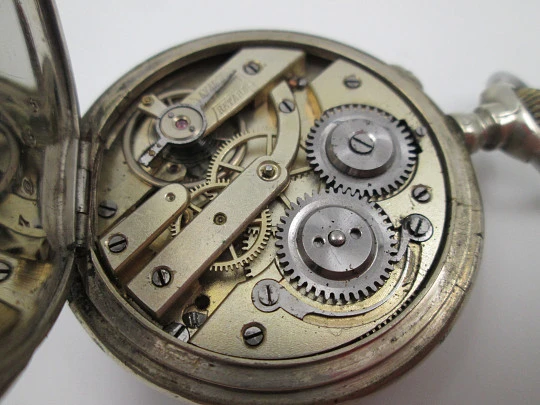 Open-face pocket watch. Nickel plated metal. Stars pattern. Stem-wind. Bitone dial. 1920's Open-face pocket watch. Nickel plated metal. Stars pattern. Stem-wind. Bitone dial. 1920's