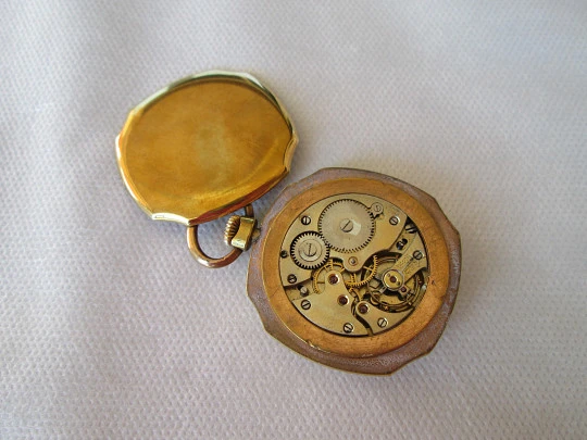 Open-face swiss pocket watch. Octogonal case. Gold plated metal
