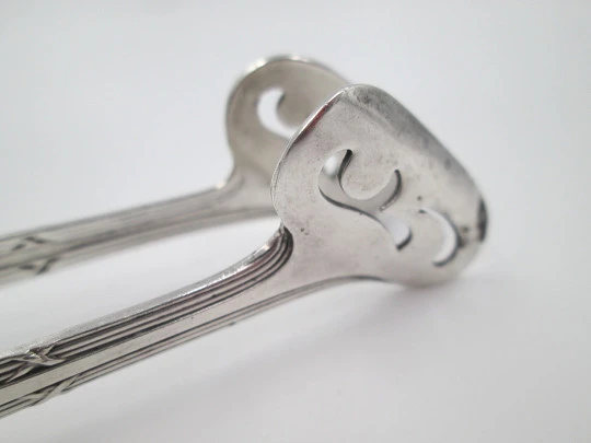 Openwork sugar tongs. Silver plated metal. Ribbed design and wheat ears. 1950's