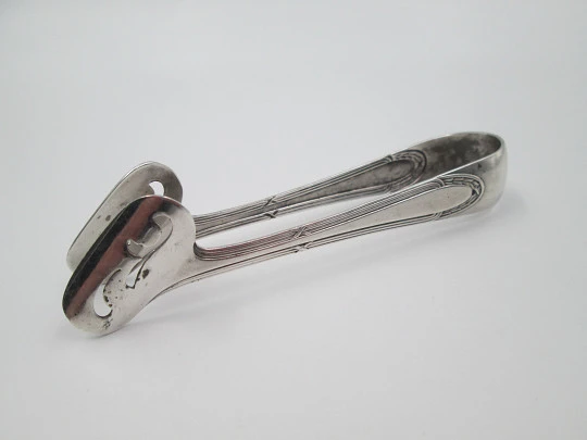 Openwork sugar tongs. Silver plated metal. Ribbed design and wheat ears. 1950's