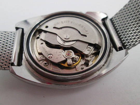 Orient. Acero inoxidable. Dial verde. Cristal facetado. Calendario. Automático. Brazalete