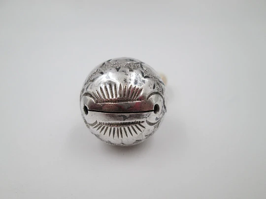 Ornate sphere baby rattle. Sterling silver. Vegetable motifs. White resin ring. 1970's