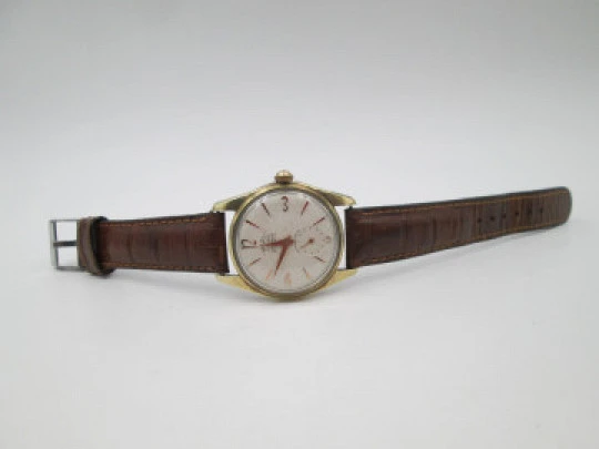 Orval. Gold plated and stainless steel. Textured dial. Small seconds hand. Manual wind. 1960's