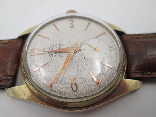 Orval. Gold plated and stainless steel. Textured dial. Small seconds hand. Manual wind. 1960's