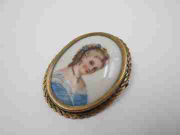 Oval brooch. Limoges painted porcelain and golden metal. Woman bust. 1950's