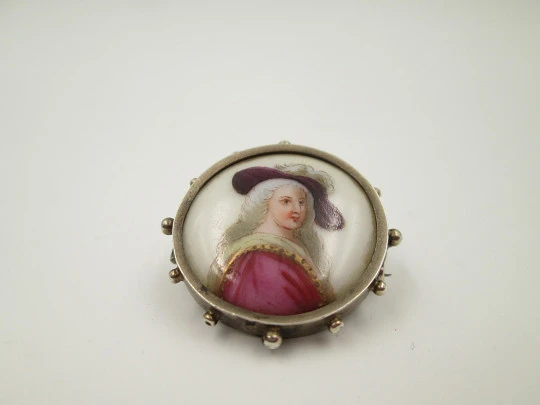 Painted porcelain and sterling silver brooch. Eighteenth century woman. Balls edge. 1940's