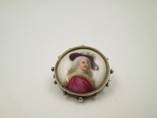 Painted porcelain and sterling silver brooch. Eighteenth century woman. Balls edge. 1940's