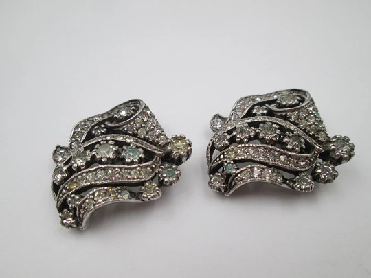 Pareja de broches / clips de vestir para mujer. Metal plateado y pedrería. Francia. 1910