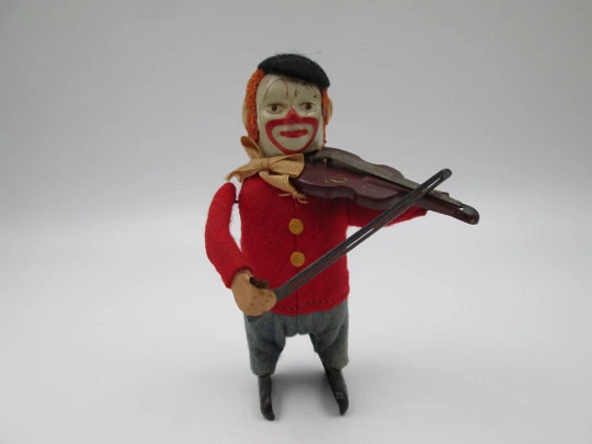 Payaso violinista mecánico Schuco. Hojalata y fieltro. Cuerda a llave. Alemania. 1930