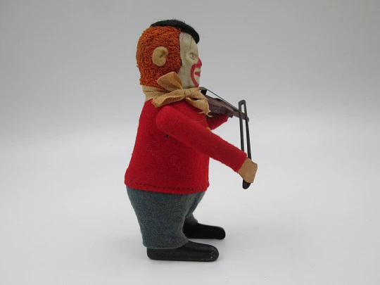 Payaso violinista mecánico Schuco. Hojalata y fieltro. Cuerda a llave. Alemania. 1930