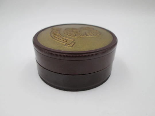 Pelikan round garnet bakelite box with golden front. Screw lid top. Germany. 1950's